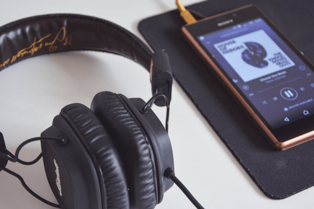 Smartphone streaming music through compatible wireless headphones.