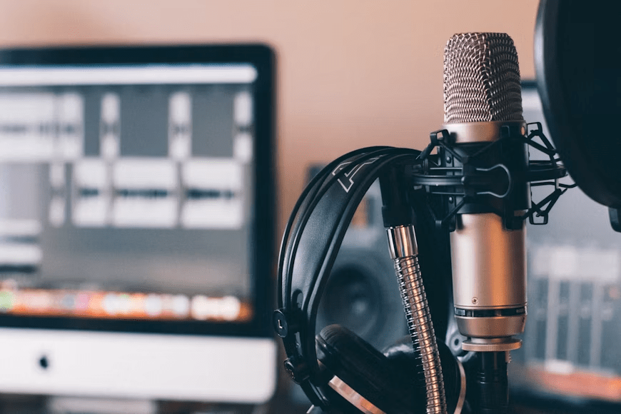 Person listening to podcast episodes on different devices while working.